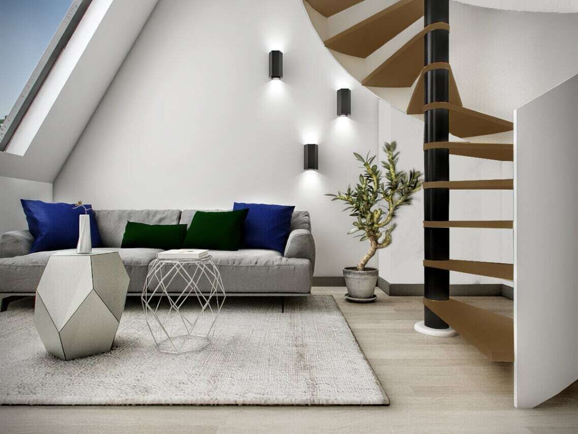 A modern living room with a grey sofa, geometric side table, and a potted plant.