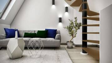 A modern living room with a grey sofa, geometric side table, and a potted plant.