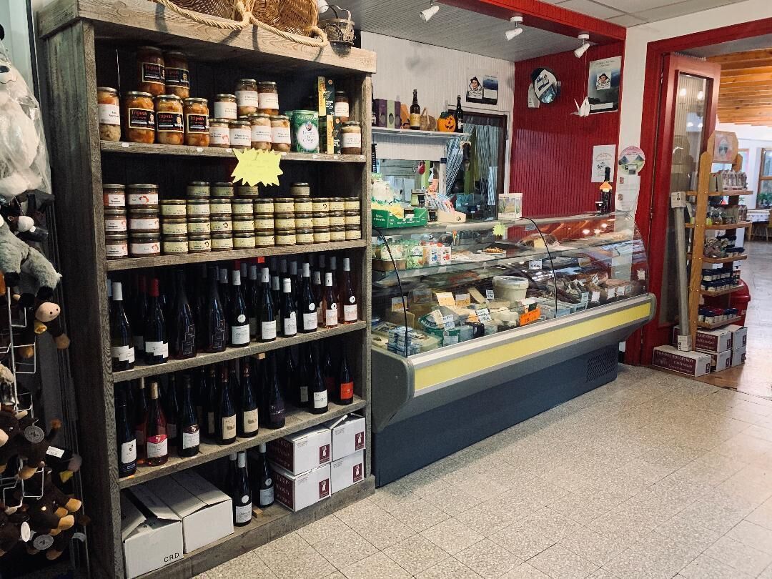 A store with shelves of wine bottles and canned goods.