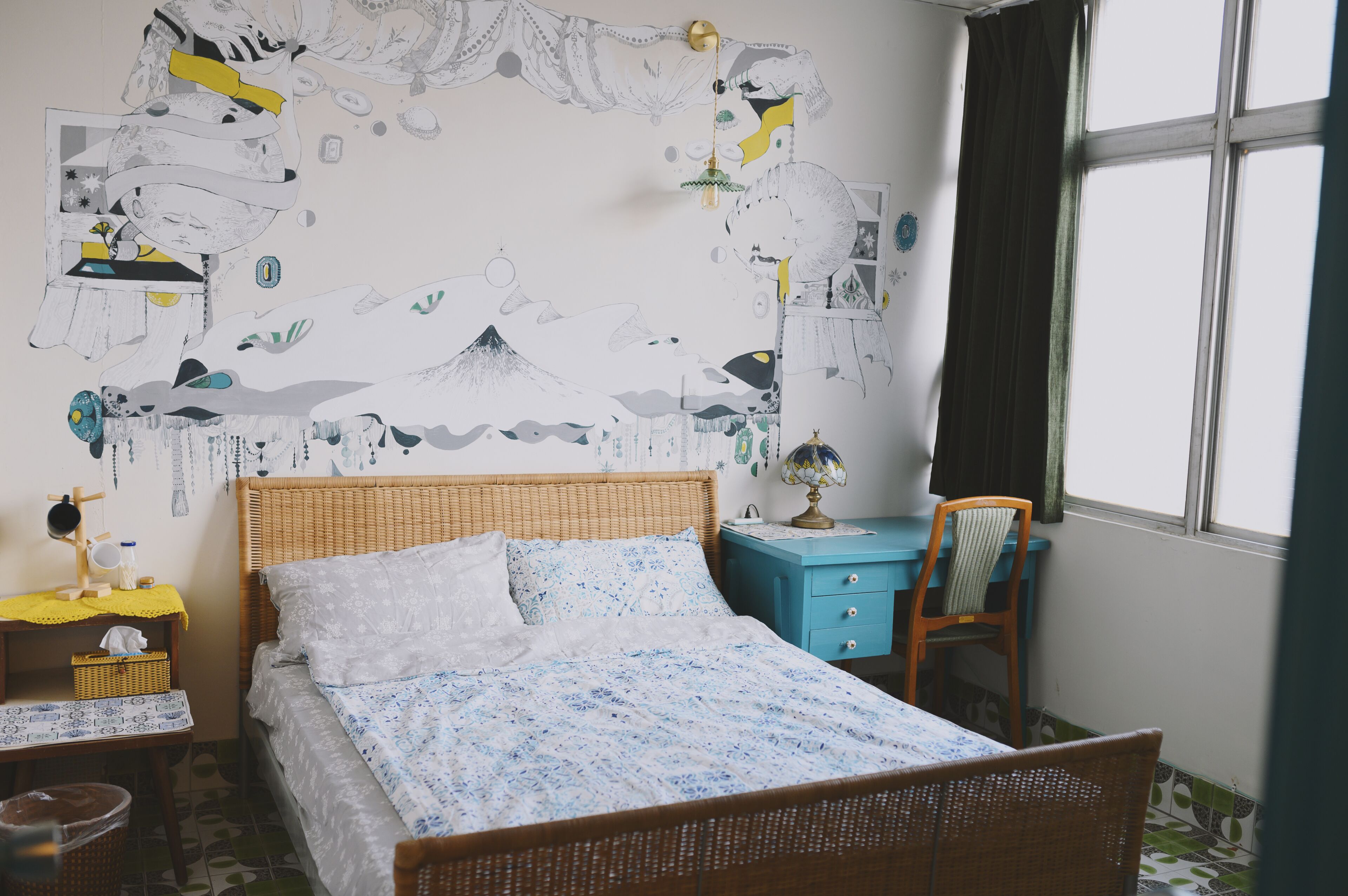 A bedroom with a bed, a desk, a chair, and a window.