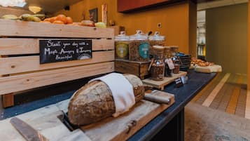 A breakfast buffet with various food items and a sign that reads "Start your day with a Magic, Amazing & Inspiring Breakfast".