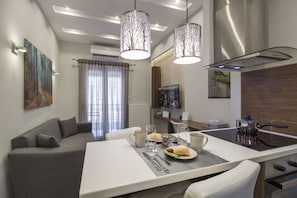 A modern dining area with a central island, a sofa, and a kitchen with a stove.