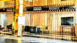 A lobby with a checkered floor, a reception desk, and several seating areas. - Grace Cox Smart Hotel (Cox's Bazar)