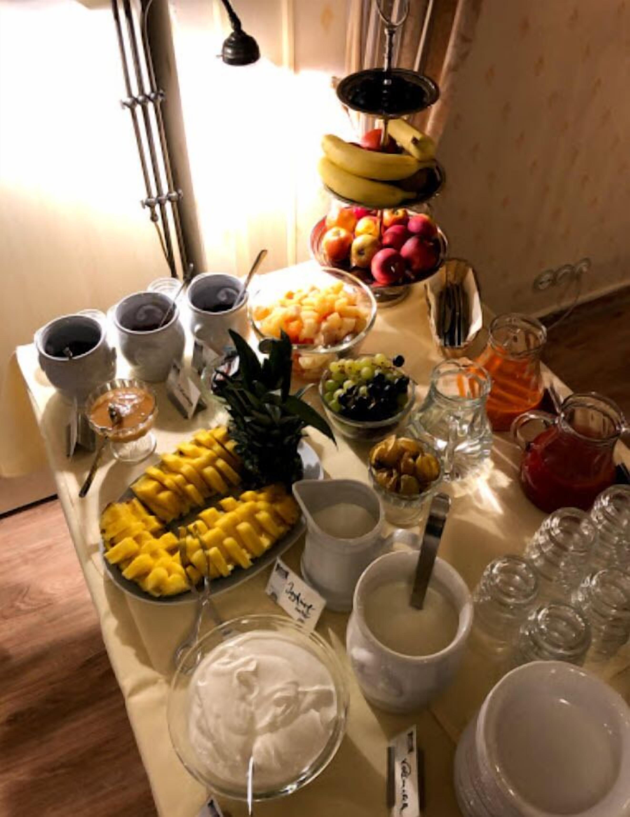 A buffet table with various food items and beverages.
