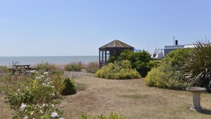 A gazebo in a garden with a view of the sea. - Beach Garden (Pevensey)