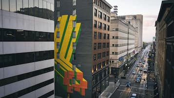 A multi-story building with a large, colorful mural on its side.