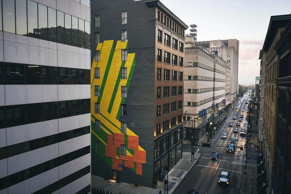 A multi-story building with a large, colorful mural on its side.