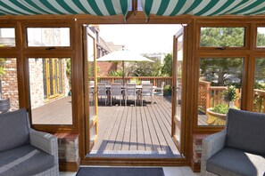 Relax in a serene garden setting with a patio and comfortable seating areas.