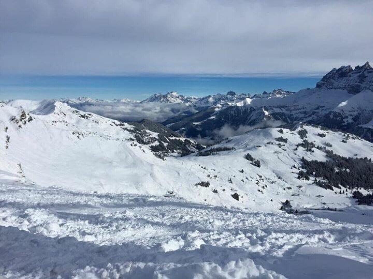 A snowy mountain landscape with clear skies.