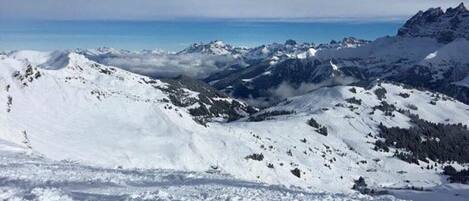 A snowy mountain landscape with clear skies.