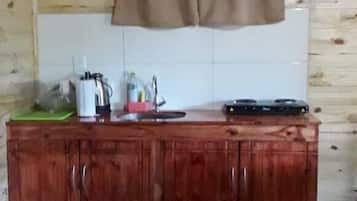 Mini-fridge, stovetop, coffee/tea maker, cookware/dishes/utensils