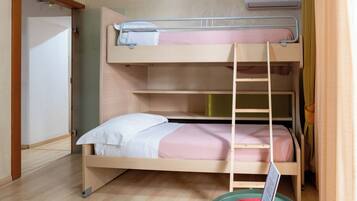 A bunk bed room with a ladder, a white door, and a window.