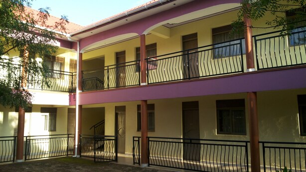 A multi-story building with balconies and a central staircase.