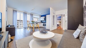 Um apartamento moderno com sala de jantar, cozinha e sala de estar.