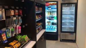 A vending area with snacks, beverages, and a Coca-Cola refrigerator.
