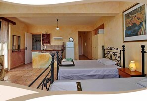A room with two beds, a small kitchenette, and a bathroom. - Aphrodites Studios (Istiaia-Aidipsos)