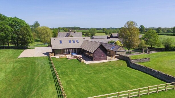 A large farmhouse with multiple rooms, a stone wall, and a well-maintained lawn. - The Cotswold Manor Court, Exclusive Hot Tub, Games Barn, 70 acres of Parkland (Bampton)