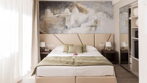 A hotel room with a large bed, two bedside tables with lamps, a large abstract painting on the wall, and a wardrobe with a mirror. - Villa Cavalletti (Grottaferrata)