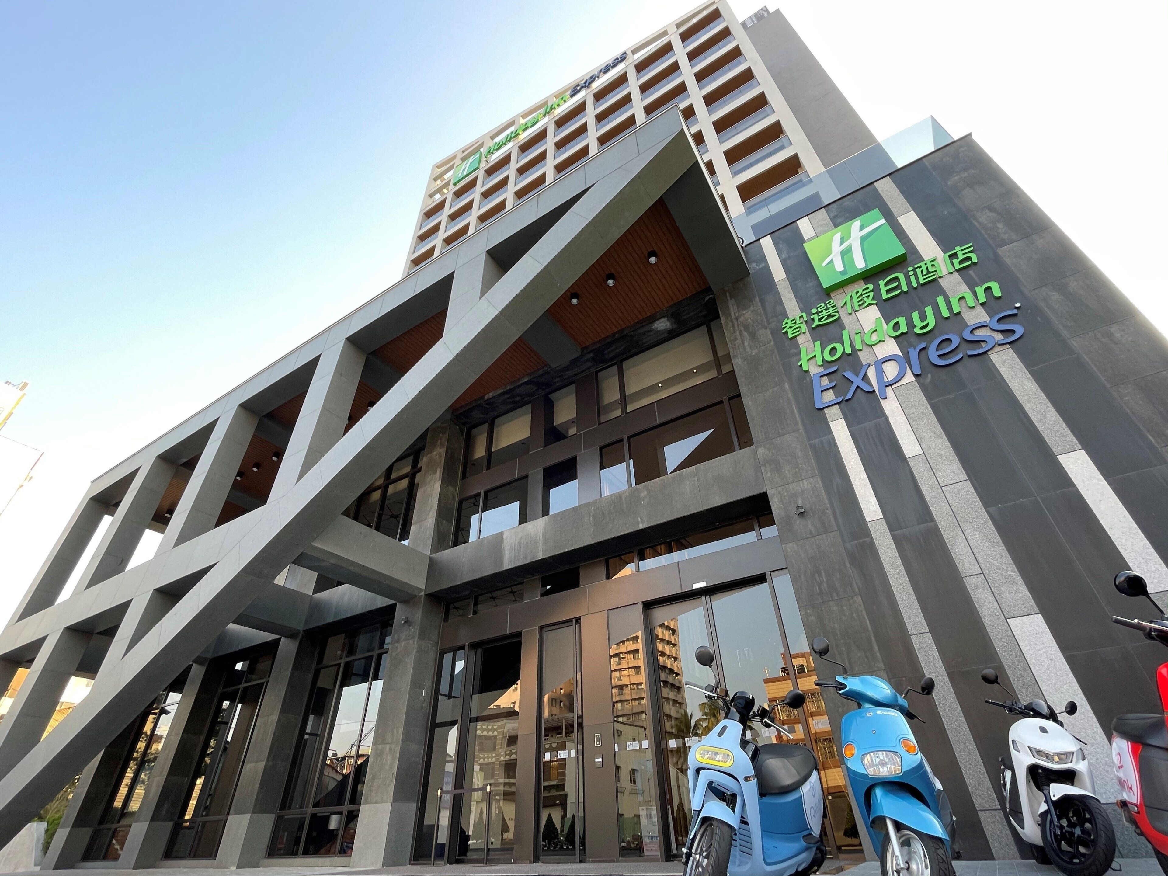A modern building with a prominent sign for Holiday Inn Express.