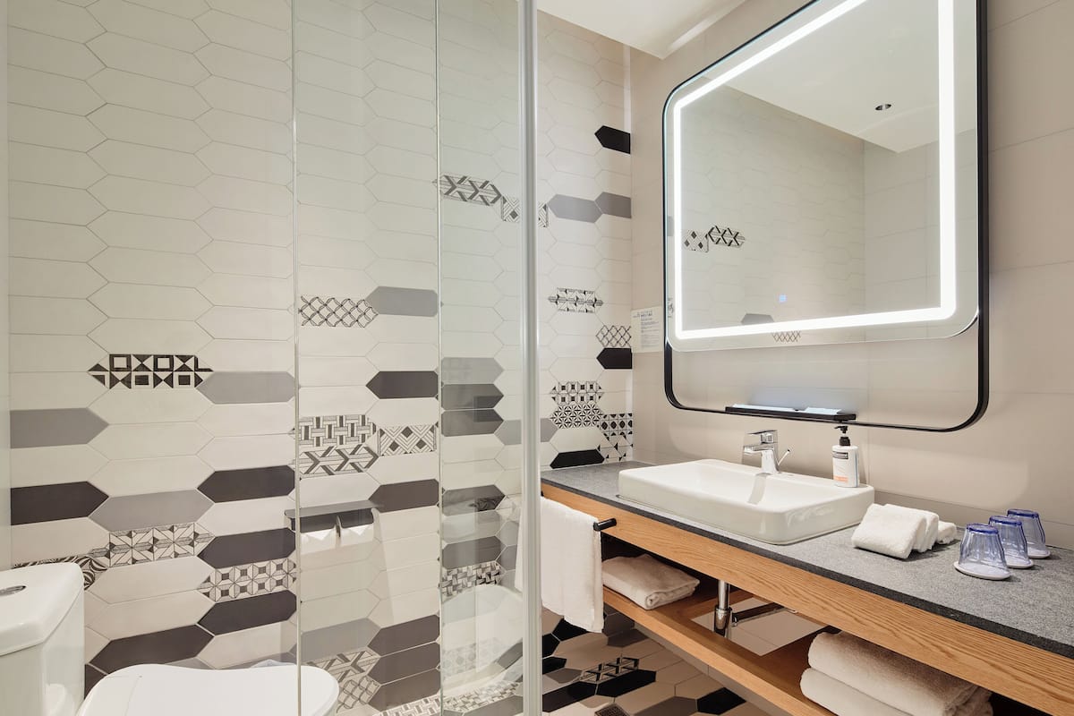 shower, designer toiletries, hair dryer, slippers