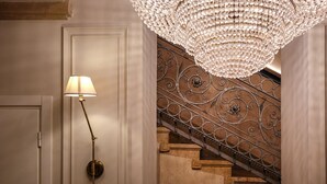A staircase with ornate metal railings and a large, ornate chandelier. - Matilde Boutique Hotel, WorldHotels Elite (Milan)