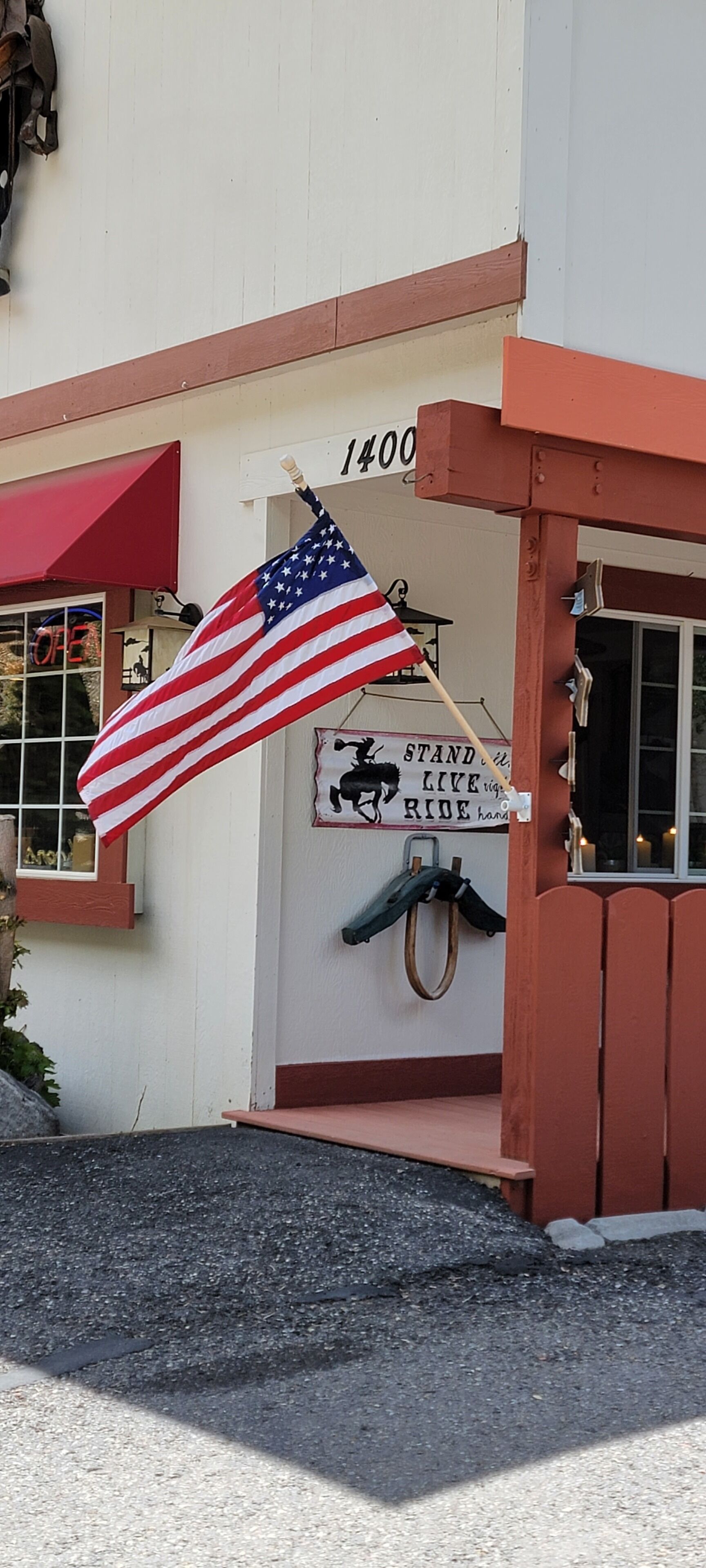 A building with a red awning and a sign that reads "1400".