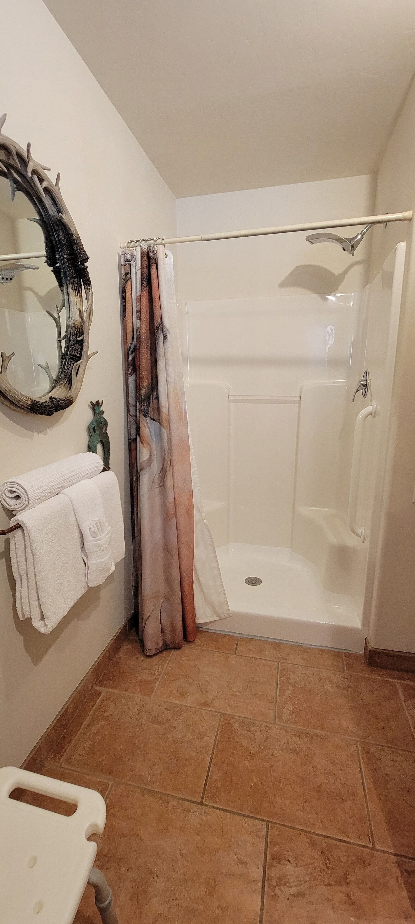 A bathroom with a shower, a toilet, and a sink.
