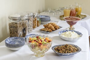 A breakfast buffet with various food items and beverages. - Sissinghurst Castle Farmhouse (Cranbrook)