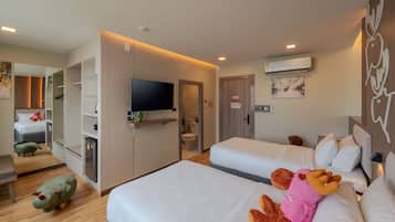A hotel room with two beds, a TV, a mirror, and a small kitchenette.