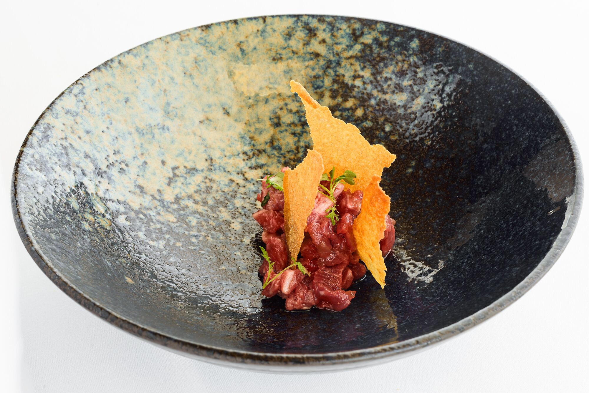 A dish with a textured black plate.