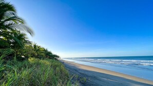 A beach with a clear sky and ocean waves.