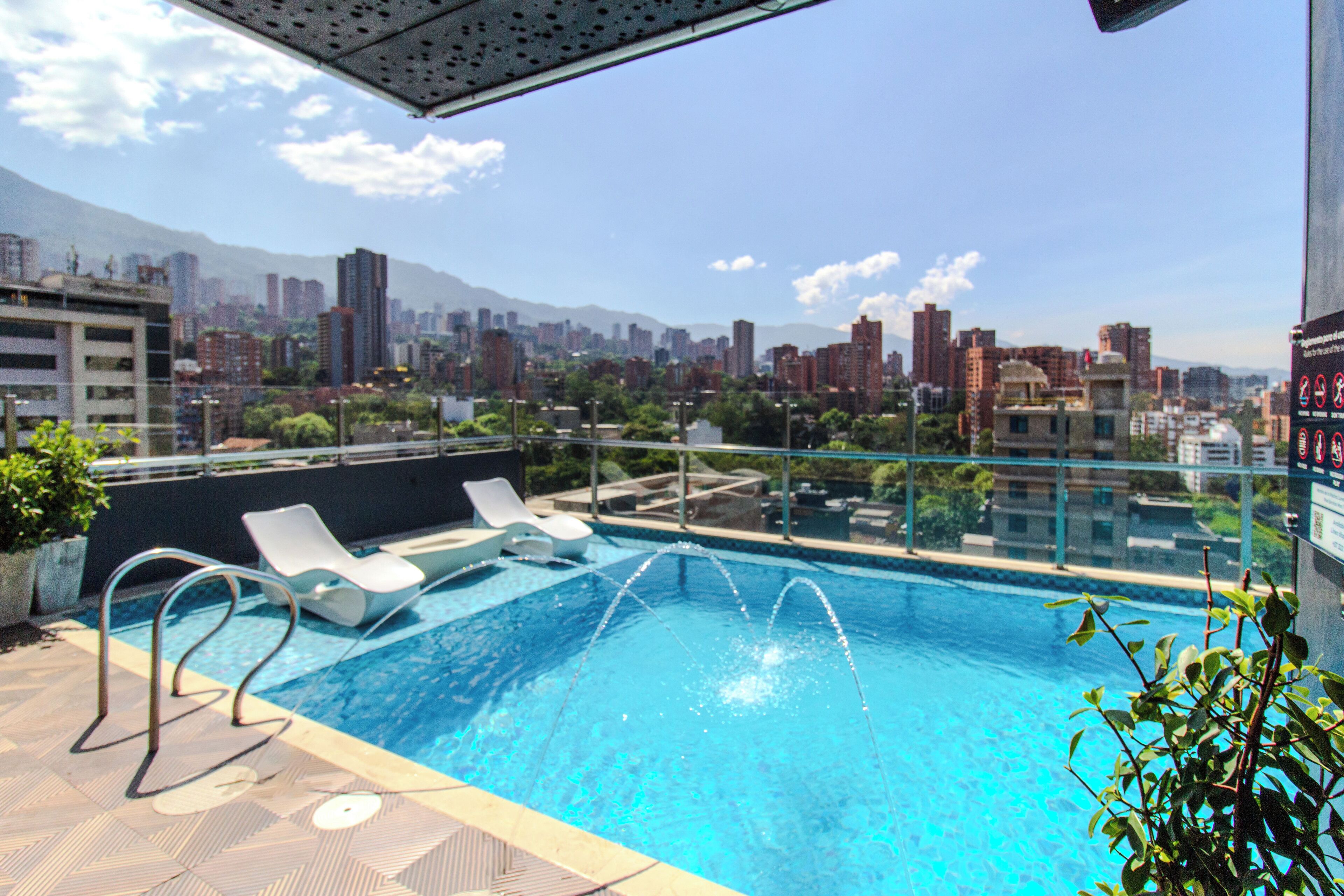 Outdoor pool, open 8:00 AM to 7:00 PM, pool loungers