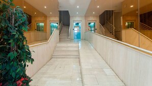 A marble staircase leading to an elevator in a hotel lobby. - STUDIO MUÑOZ # 5 · Studio Muñoz # 5 Old town, 5 minute to beach (Alicante (Alacant))