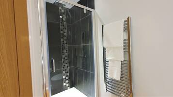 Shower, hair dryer, towels, shampoo