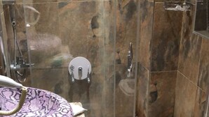 A bathroom with a glass-enclosed shower, a sink with a patterned basin, and a toilet. - Gülhane Hotel (Istanbul)