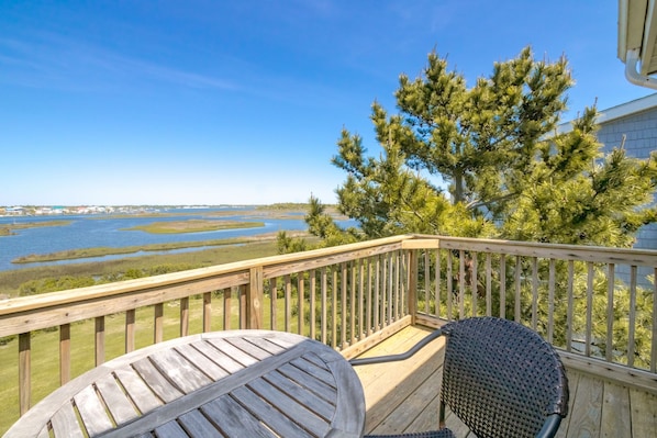 A wooden deck with a view of a water body and trees. - Island In The Sun - 3BR Townhouse with Ocean & Sound Views! (North Topsail Beach)