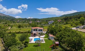 A two-story house with a red roof, a swimming pool, and a small play area. - VILLA ROKO with 4 bedrooms, 32sqm heated pool, playground,  8 persons (Tugare)