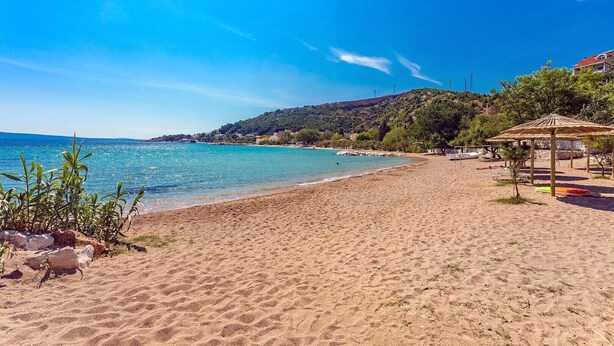 A beach with clear blue water, a sandy shore, and a small gazebo. - VILLA ROKO with 4 bedrooms, 32sqm heated pool, playground (Tugare)