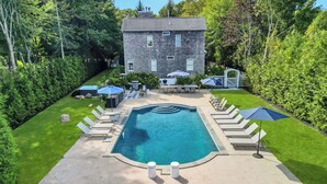 A backyard with a swimming pool, lounge chairs, and a barbecue area. - COLONIAL COMPOUND WITH OVERSIZED LIVING ROOMS, GYM, AND ARCADE ROOM, CLOSE... (Southampton)