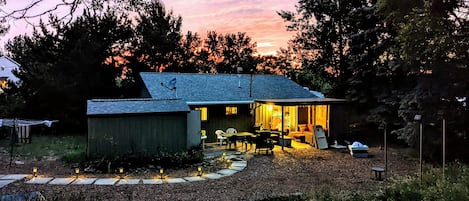 A small house with a porch, a dining area, and a visible kitchen area.