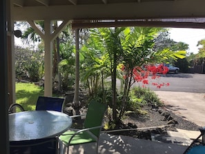 Relax in a serene outdoor space surrounded by lush greenery and comfortable seating.