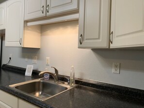 Fridge, high chair, cookware/dishes/utensils, spices