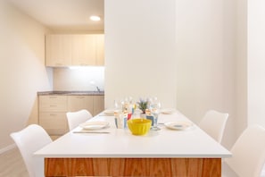 Enjoy meals in a bright and airy dining area with a clean, minimalist design.