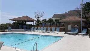 A swimming pool with lounge chairs and a gazebo. - Surf Suites (Wrightsville Beach)
