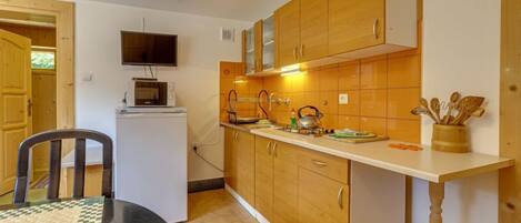 Fridge, cookware/dishes/utensils, dining tables