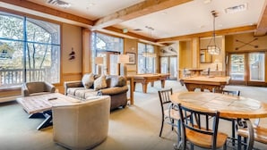 A spacious room with a pool table, a sofa, and a dining table with chairs. - River Run - Steps to Ski, Hot Tubs, Heated Pool, Ice Rink (Keystone)