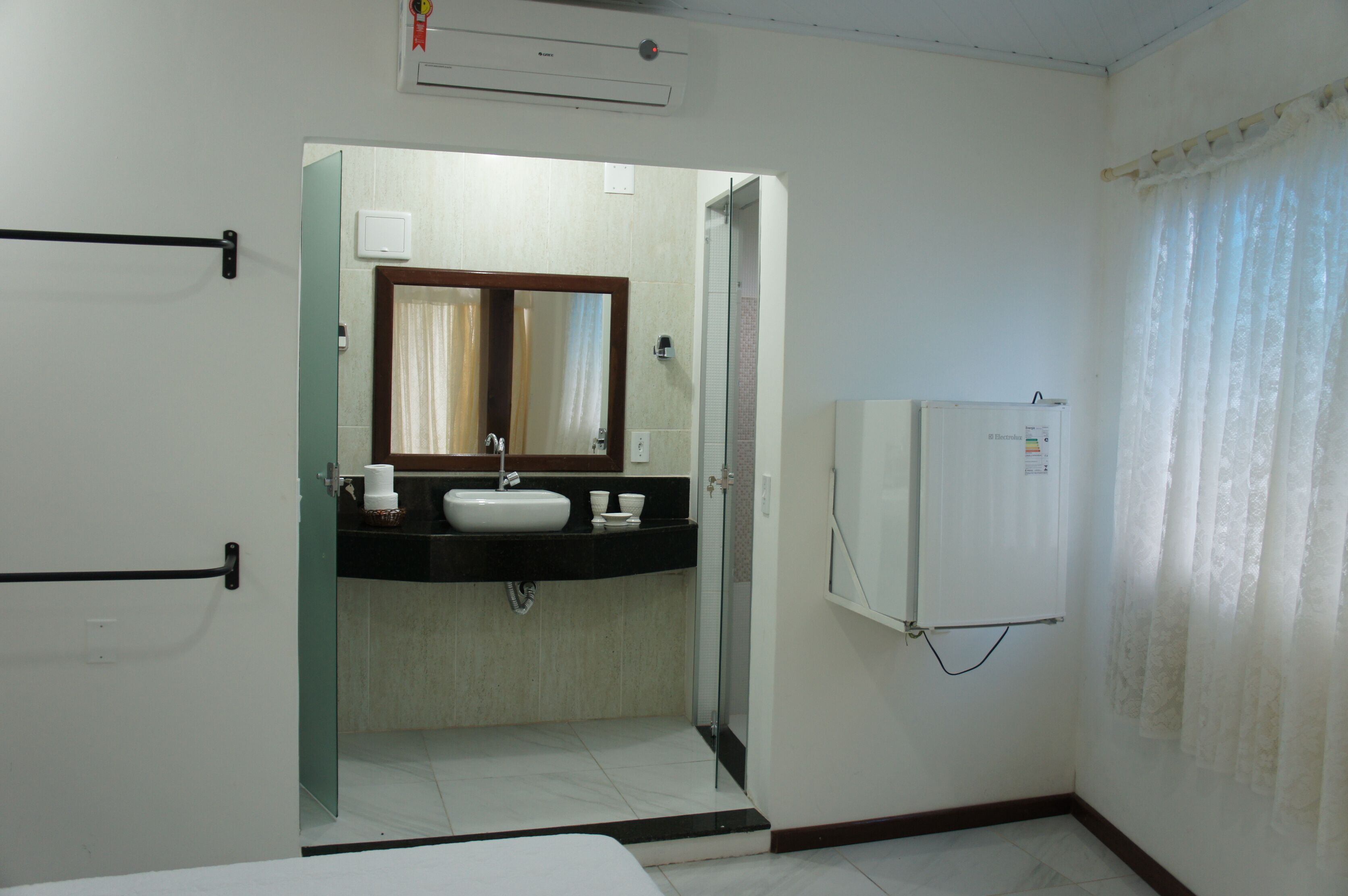 A bathroom with a sink, mirror, and toilet.