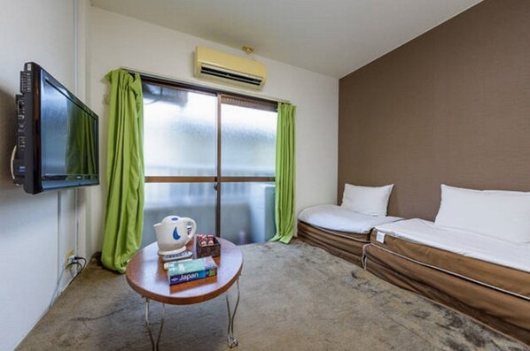 Relax in this inviting space with a large bed, TV, and a small table for reading and enjoying a cup.
