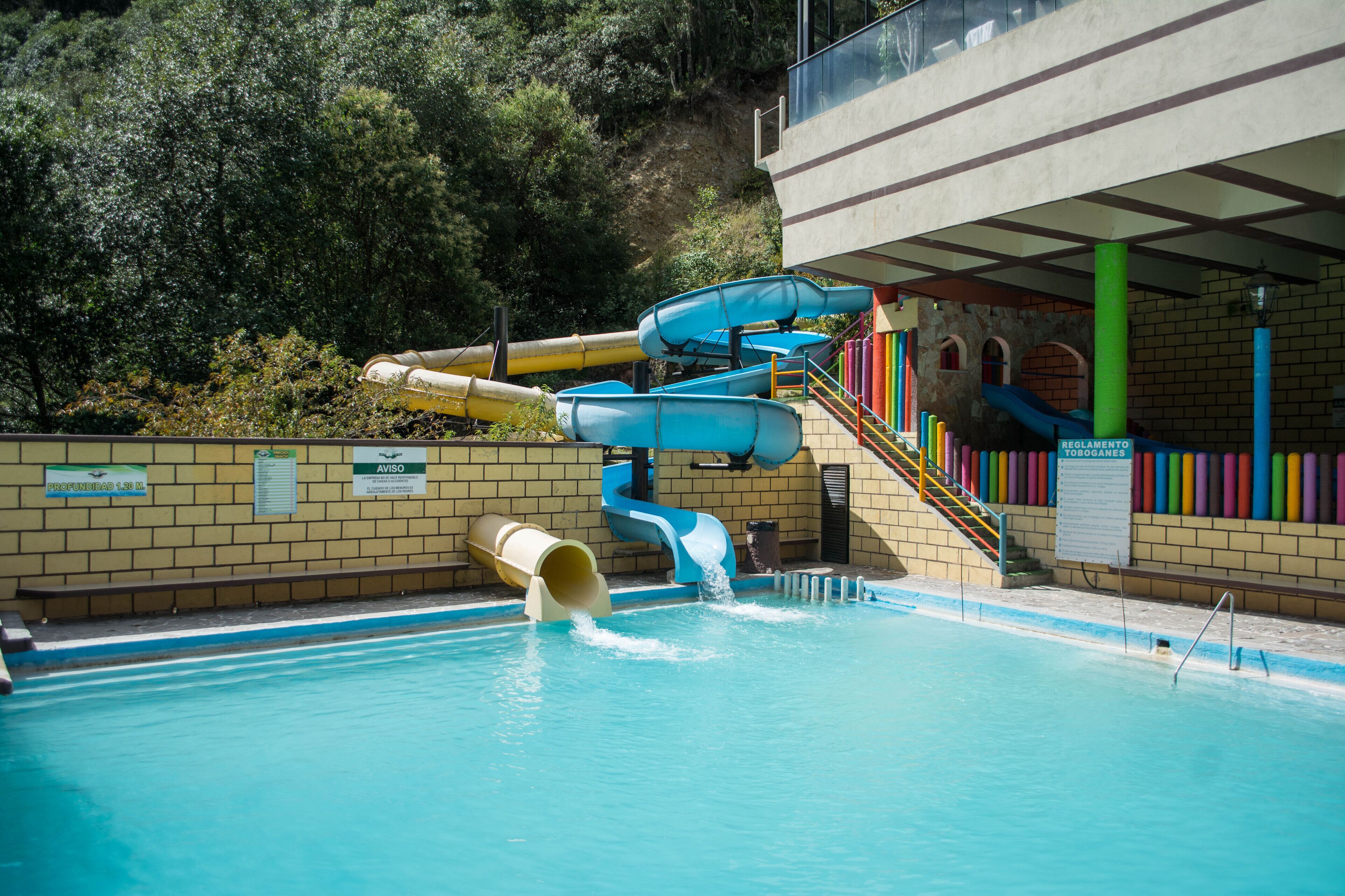 A water park with multiple slides and a pool.