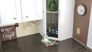 A kitchen with white cabinets, a wine rack, and a clock on the wall. - Randy's Rathbun Rental.  "Your Home Away From Home"  Fully Furnished Sleeps 6 (Moravia)